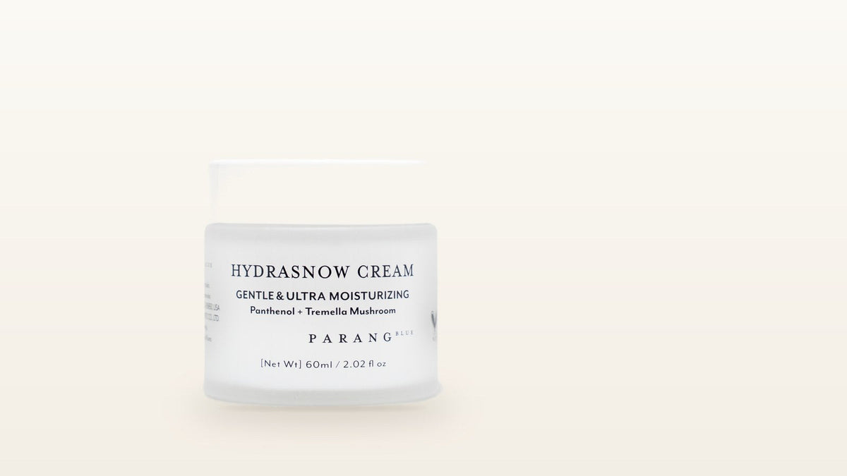 Parang Blue Hydrasnow Cream jar on a cream background