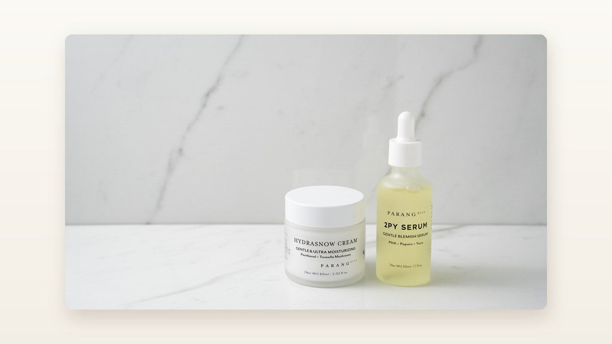 Parang Blue Hydrasnow Cream and 2PY Serum on a marble counter