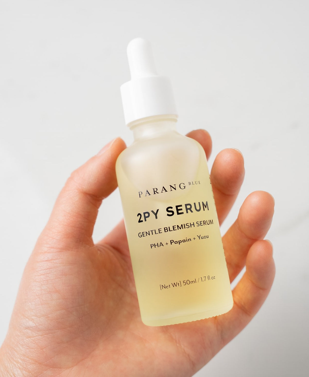 The 2PY Serum held in a hand